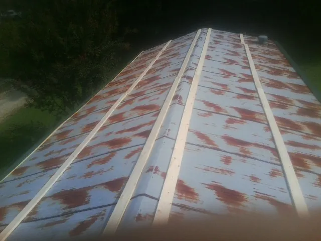 Rusted metal roof panels with new wood purlins before replacement — Storm Damage Roof Repair in Wellesley by Roofing Brothers